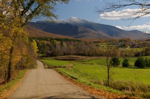 Fall foliage in Cambridge, Vermont with snow capped Mt. Mansfield.