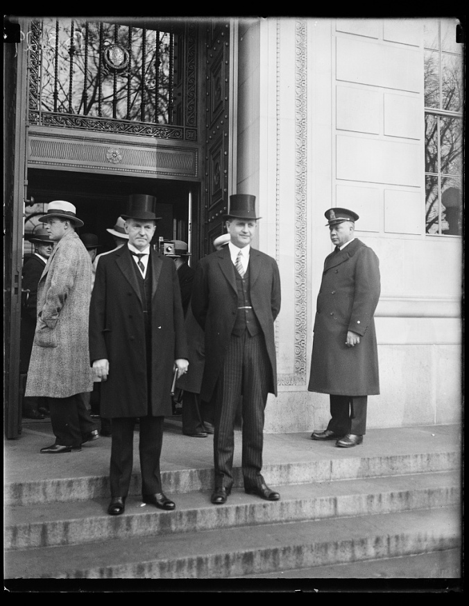 President Coolidge with his secretary, Everett Sanders, outside the International Civil Aeronautics Conference, December 12, 1928. 