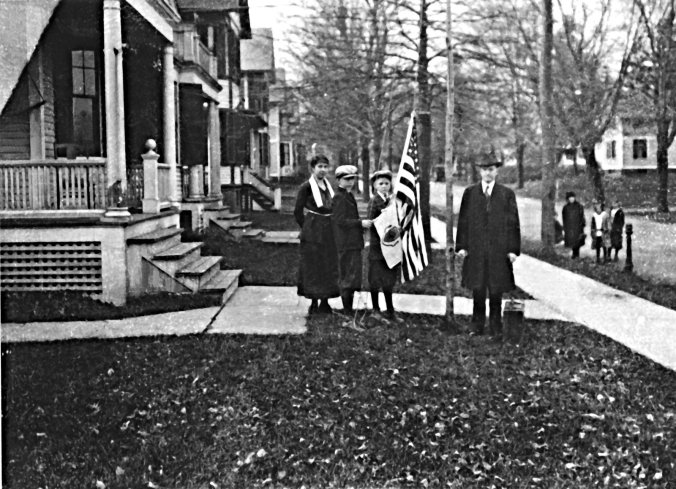 The Coolidge family, on Massasoit Street in Northampton, raising the flag, Thanksgiving Day, 1919