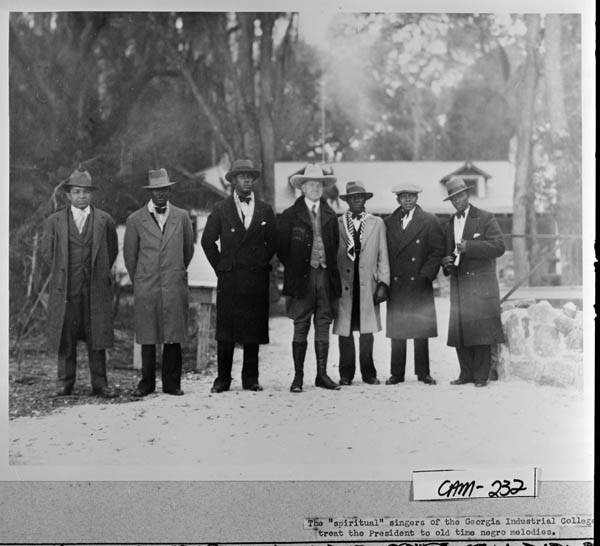 President Coolidge at Cabin Bluff with the "spiritual" singers of Georgia Industrial College. 