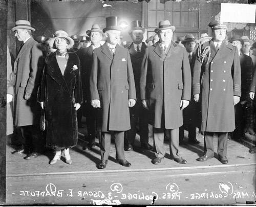 The Coolidges are standing with Oscar Bradfute, to the President's left, in a picture taken in Chicago before Coolidge's address. 