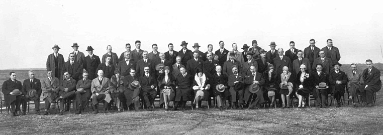 Delegates pose for a group photograph on December 15th, at Langley Memorial Aeronautical Laboratory. Orville Wright is seated in the front row to the right of the woman with the white fur collar. 