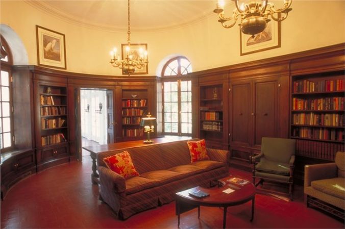 The library where President and Mrs. Coolidge had their portraits painted. The background for the First Lady's portrait is the picturesque Spanish moss and green lawns of this, as with so many, Southern mansions. 