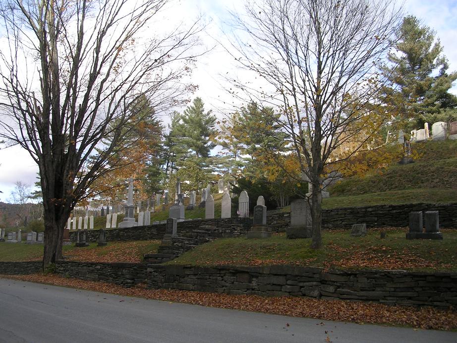 The Coolidge family headstones stand in a row at the center of the picture, Plymouth cemetery, The Notch. "Here my dead lie pillowed on the loving breast of our everlasting hills" -- Calvin Coolidge