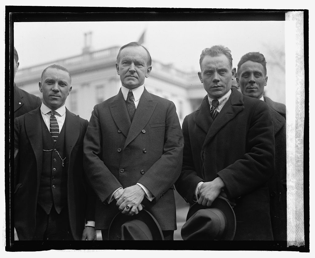 American track runner and Olympic bronze winner Joie Raye (L of Coolidge) and Paavo Nurmi of Finland (R), who would win his ninth gold medal at the Olympics in 1928 in long distance running. Raye and Nurmi (the "Flying Finn") visited President Coolidge at the White House on February 21, 1925. 