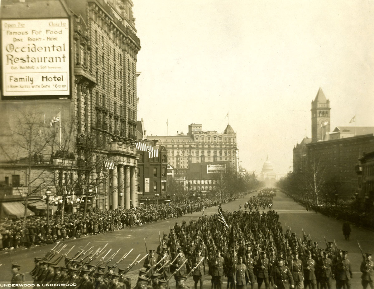 View down Pennsylvania Avenue with the Capitol in the background, as a wide variety of America's servicemen march in honor of President Coolidge's inauguration. 