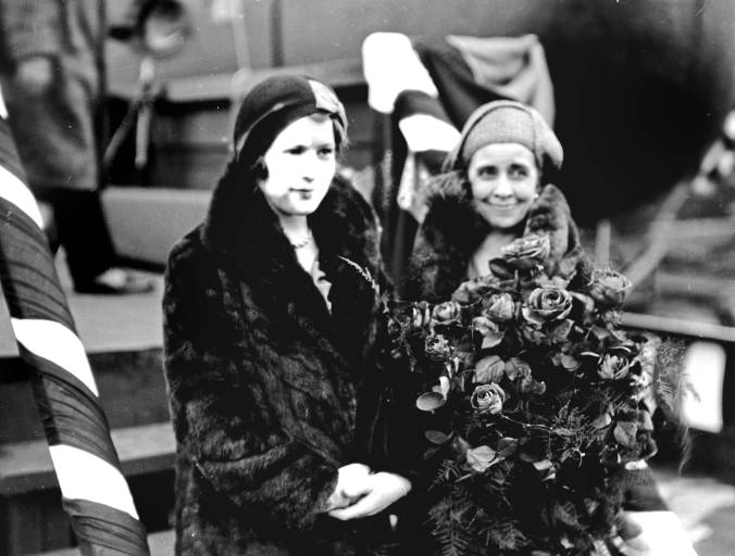 Both Mrs. Coolidge and Mrs. Coolidge stand for their picture at the dock in Newport News, Virginia. 