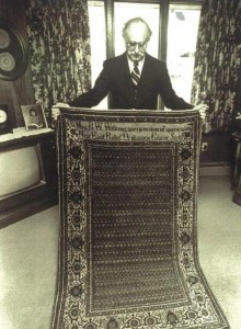 Dr. Deranian holding the sister rug to the one presented to President Coolidge, 1925. 