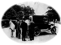 Mail truck is loaded with the Declaration and Constitution as Herbert Putnam, wearing the fedora, supervises the transfer to the Library. 