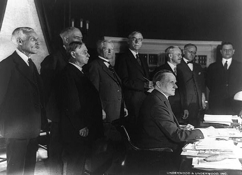 Legislators stand in the midst of the Coolidge tax policy team, with Democrat Senator Simmons directly in front of Mellon beside his fellow Democrat from the House, "Texas Jack" Garner. 