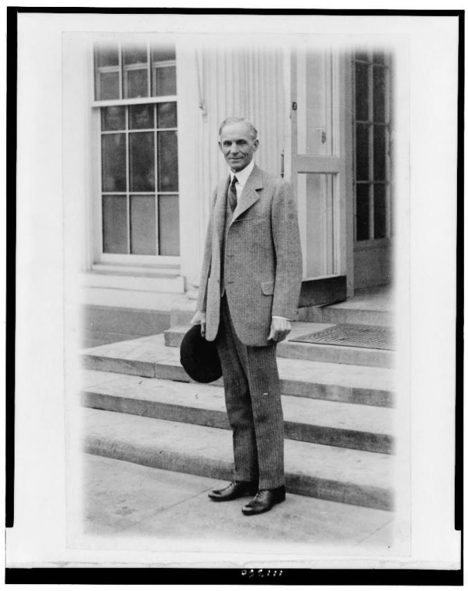 Henry Ford, after meeting with President Coolidge, 1927. Do you see the three faces peering out the window as the photographer snaps this picture? Courtesy of the Library of Congress. 