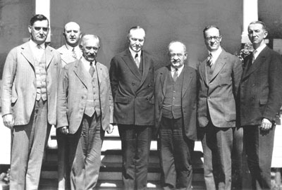 Coolidge meeting with a Knights of Columbus delegation there to discuss religious freedoms in Mexico, at the summer White House, Adirondacks, 1926. From L to R, they are: Pictured left to right are Supreme Advocate Luke E. Hart, Deputy Supreme Knight Martin Carmody, Supreme Knight James A. Flaherty, President Coolidge, Supreme Secretary William J. McGinley, Supreme Director William C. Prout, and Assistant Supreme Secretary John Conway. 