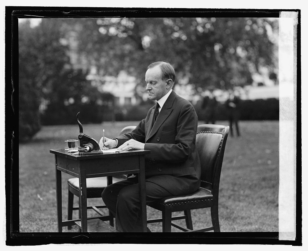 President Coolidge filling out his own absentee ballot to vote in his hometown elections, 1924. 
