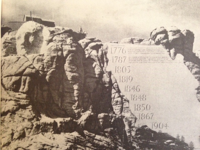 Approached by Borglum to compose a timeline to be carved into the rock beside the Presidents, Coolidge lent his talents for expression with a conscientious concern for historical accuracy to the project. It all ended abruptly, however, when Borglum published his own error-riddled revision of what then-former President Coolidge had written -- without bothering to notify him of his actions. As the press began to mistake what Borglum had written for Coolidge's original prose, Cal suspended any further participation. Since the law passed to form the Rushmore Memorial stipulated only Coolidge's words could be used for the Entablature, the idea was scrapped...almost. It would be years until a contest would recognize the winner of an Entablature essay, featured today on a bronze plaque inside the viewing facility at the foot of the mountain. 