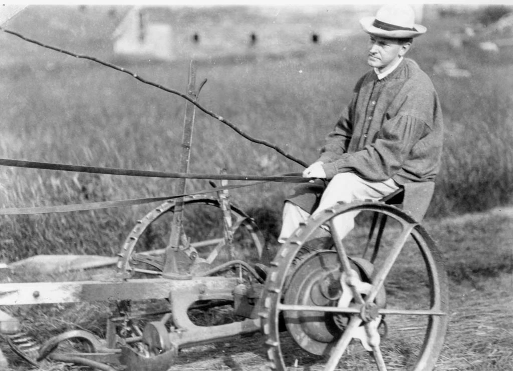 Coolidge, in his grandfather's frock, working the fields of the family Homestead. 