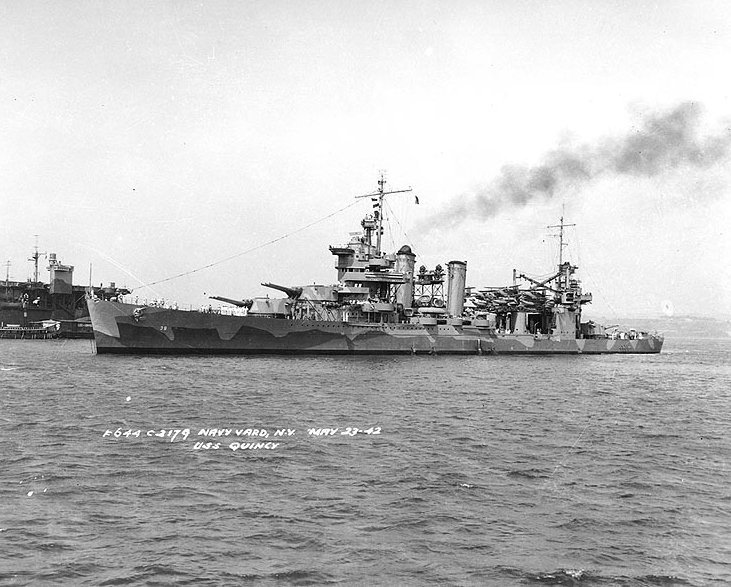 USS Quincy (CA-39), was laid down by Bethlehem Shipping Corporation out of her namesake city, 15 November 1933, launching in 1935. Operating in the Atlantic for the next seven years, she finally transferred to the Pacific theater in order to assist with the upcoming Guadalcanal offensive, decimating a Japanese oil depot and other sites vital to their war effort, before being caught during a patrol off Savo Island by a large Japanese fleet early on 9 August 1942. Taking countless hits, her guns disabled, she sank with the loss of 379 men to the ocean floor, the first to descend into what would become known as "Ironbottom Sound." 