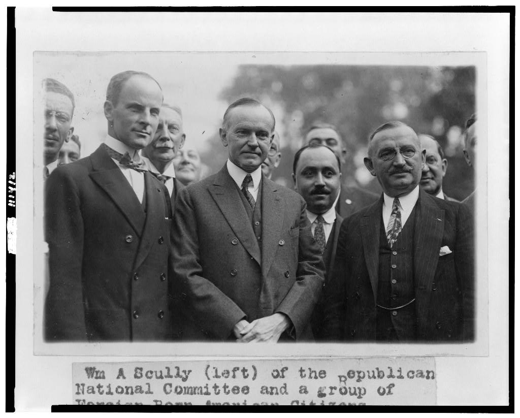 Calvin Coolidge with a gathering of newly naturalized Americans, hosted by William Scully of the Republican National Committee, 1924. 