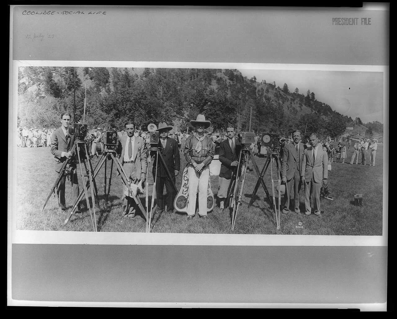 President Coolidge posing in his new gear with photographers, near the Game Lodge in Custer State Park, South Dakota. 