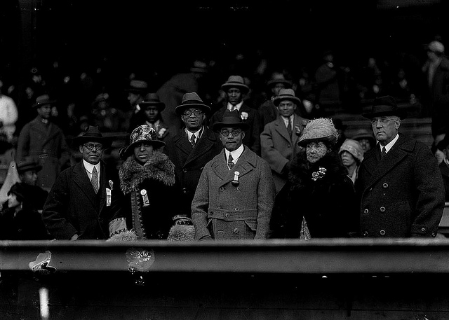 Judge James A. Cobb, appointed by Coolidge to the bench, watches a Howard University football game with friends, 1930. 