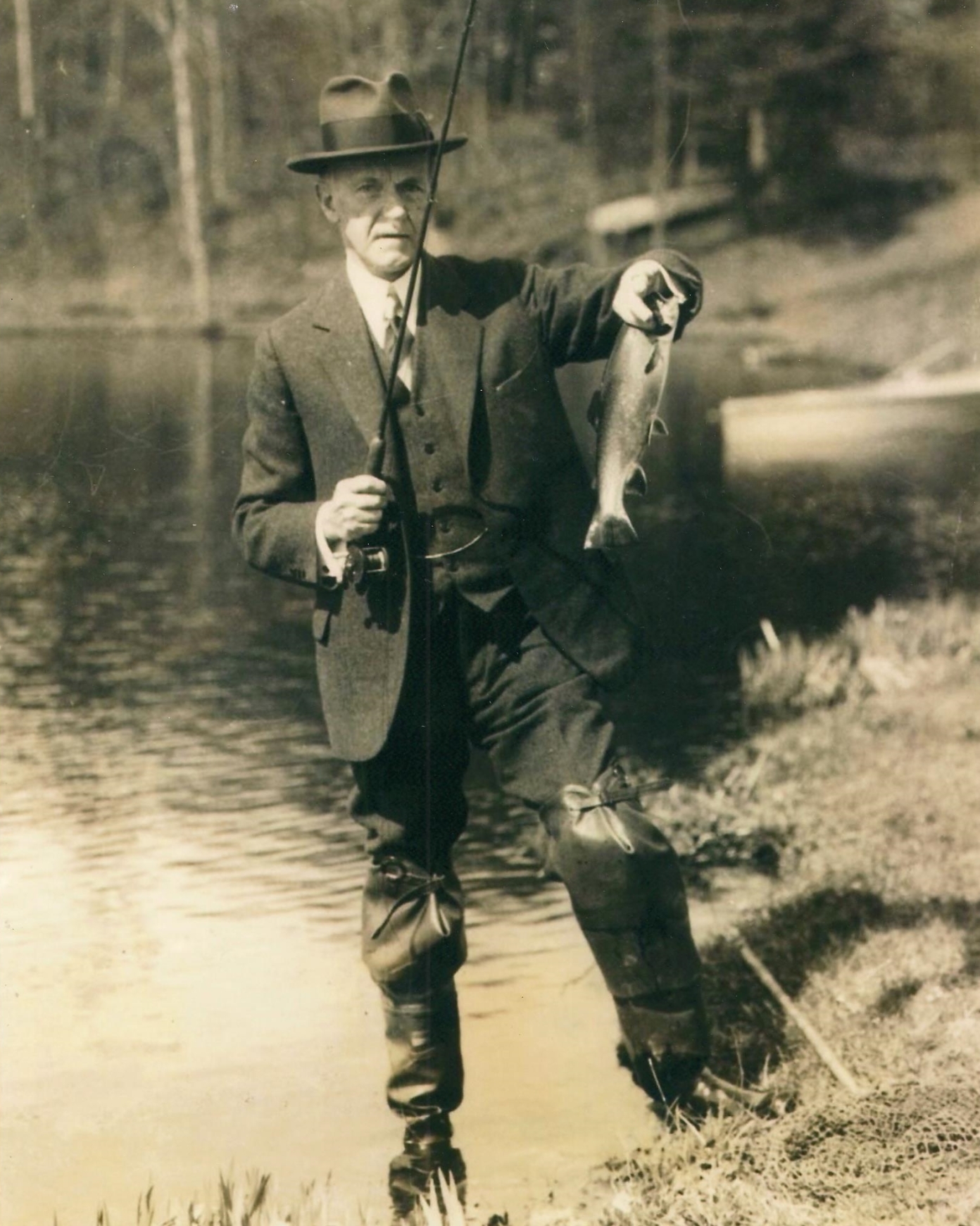 Coolidge held scrupulously to accurate fish stories. He made a point of displaying what he had caught, even documenting it for verification. Here he holds his latest catch up for visual confirmation. 