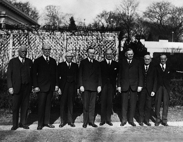 Members of the Pan American Conference to assemble in Havana, standing here on the grounds of the White House. L to R, they are: Judge Morgan J. O’Brien, New York; Charles Evans Hughes; Secretary of State Kellogg; President Coolidge; Henry P. Fletcher, American Ambassador to Italy; former Senator Oscar W. Underwood; Dr. James Scott Brown, Washington; and Dr. L. S. Rowe of the Pan American Union.