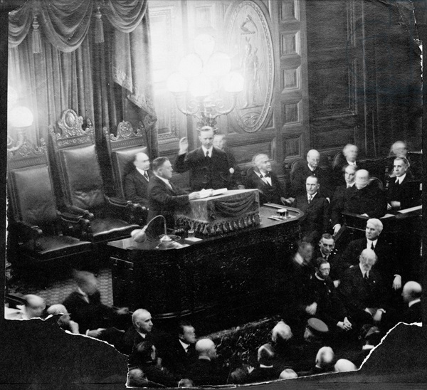 AQS254834 Calvin Coolidge (1873-1933) taking the oath of office as Governor of the State Senate, 1st January 1919 (b/w photo) by American Photographer, (20th century); American Antiquarian Society, Worcester, Massachusetts, USA; (add.info.: 30th President of the United States (1923-29);); American, it is possible that some works by this artist may be protected by third party rights in some territories