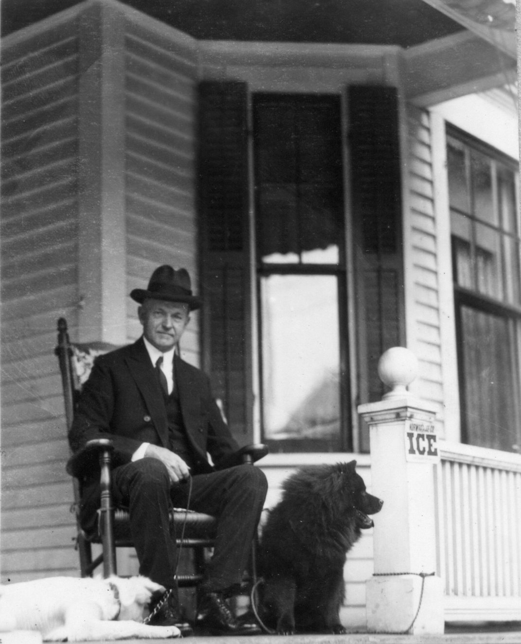 Coolidge, enjoying retirement from public life, with his dogs on the front porch of their first home, 21 Massasoit Street, Northampton, Massachusetts. 