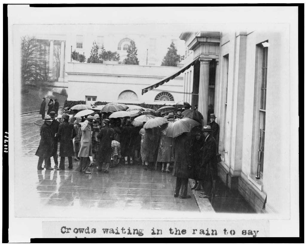 Crowds waiting in the rain to say goodbye and good luck to President Coolidge outside the White House 3-2-1929