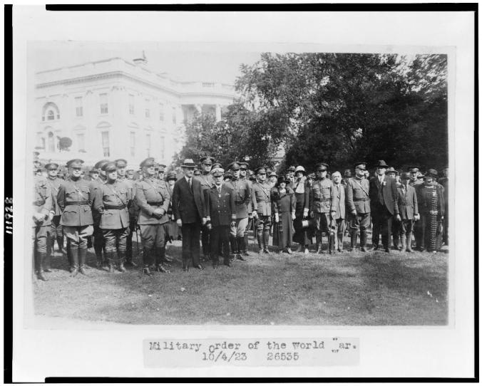 President Coolidge, standing, with members of the Military Order of the World War, on the White House lawn 1923
